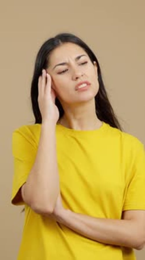 Woman Ponders, Thinking Deeply, Yellow Shirt