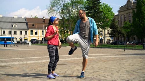 Couple talking and warming up in city square