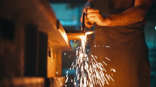 A Male Locksmith Cuts Metal with an Oxyfuel Torch in a Metal Cutting Workshop