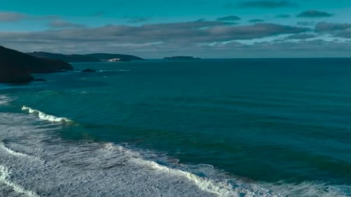 Seascape With Foamy Waves Rolling Onto Shoreline - Aerial Panoramic