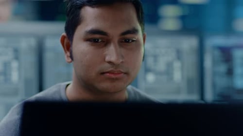 Man Focused on Computer Screen in Office