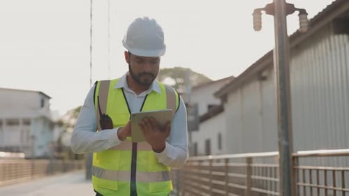 Portrait of Inspector with Tablet Computer Checking Buildings and Workshops