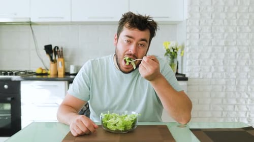 Man Eating Healthy Salad in Modern Kitchen