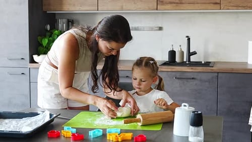 Mother and Child Baking Together in Kitchen