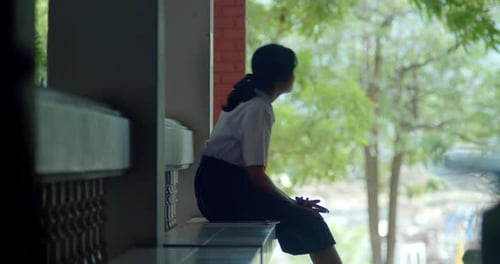 A silhouette scene of a young Asian high school girl with a highly private world or introvert