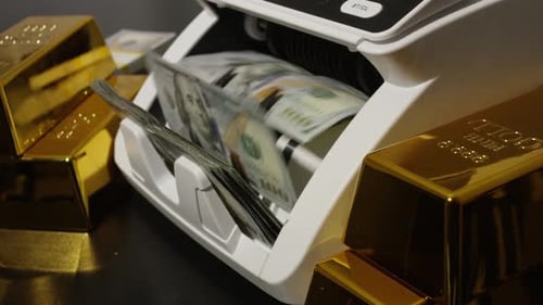 Money Counter Counting Stacks of US Dollar Bills