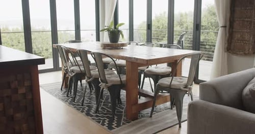 General view of dining room with table and chairs, slow motion