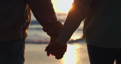 Beach silhouette, sunset and couple walking, holding hands and journey to ocean waves