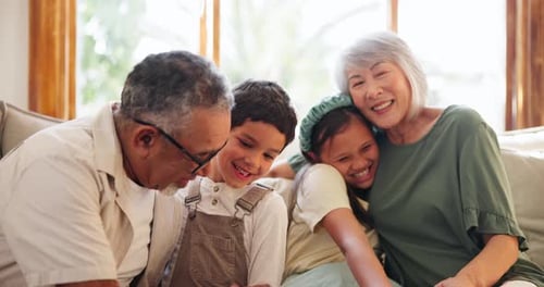 Affectionate Grandparents with Grandchildren Smiling Together at Home