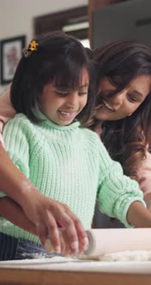 Child and Woman Baking Together in Kitchen