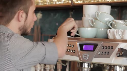 Bearded Barista Operating Espresso Machine