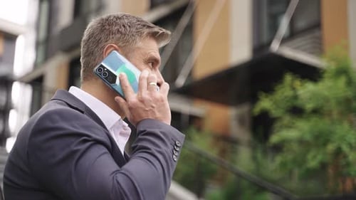 Happy Adult Businessman Talking on the Phone in the City Slow Motion