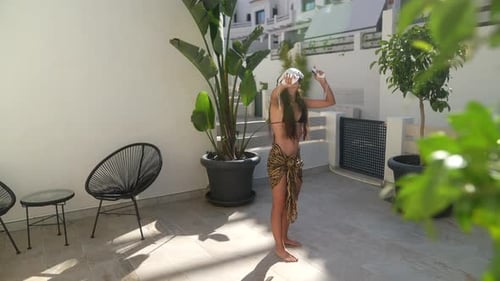 Woman Experiences Virtual Reality on Sunny Patio