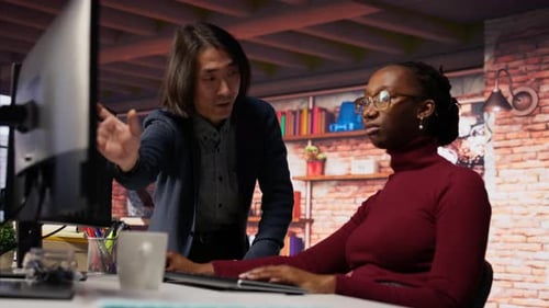 Man in AI Startup Office CTO Position Overseeing Software Engineer Coding