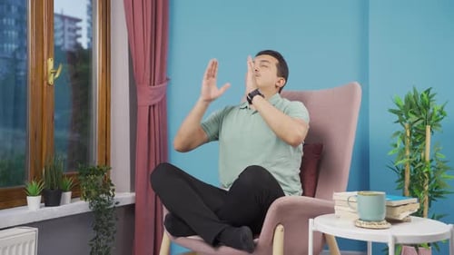 Man Meditating in Chair with Eyes Closed
