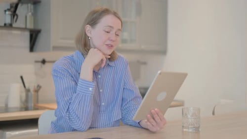 Woman Video Chatting Using Tablet Device