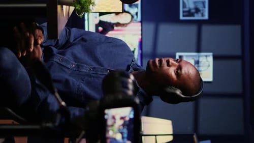 Man Speaking Into Microphone While Recording Video