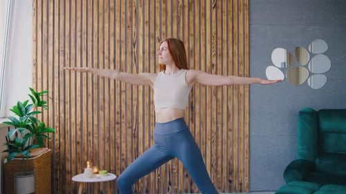 Woman Doing Yoga Warrior Pose at Home