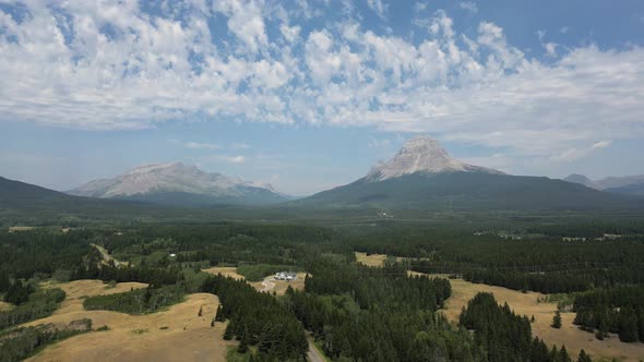 View of Ranch With Majestic Mountains, Cloudy Sky. Crowsnest Pass, AB ...