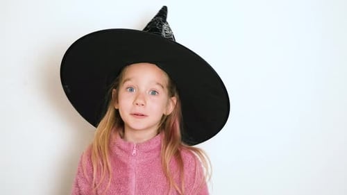 Smiling Child in Witch Hat Dancing and Smiling