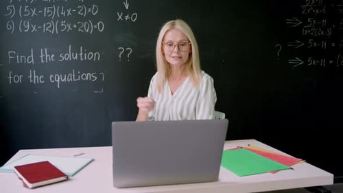 Teacher Explains Math Equations During Online Tutoring Session