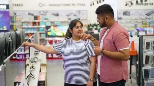 Looking for a New Smart TV Indian Couple at Tech Store