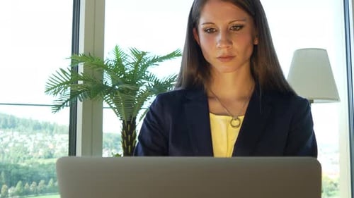 Professional Woman Works on Laptop in Office