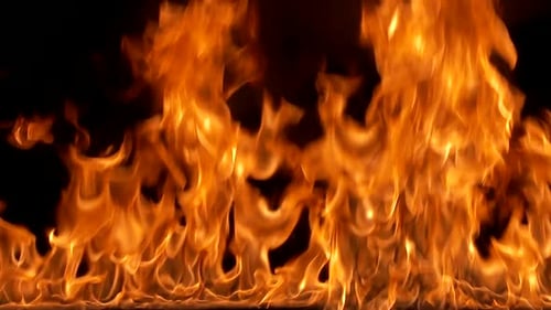 Fire burns on the ground. Can be used as a video texture or background for design projects, scenes.