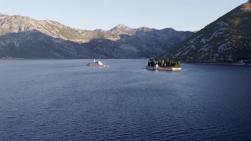 Aerial view of tranquil Kotor Bay with historical church, Montenegro.