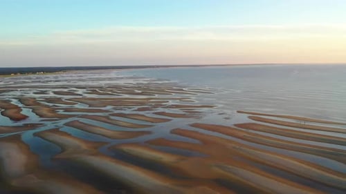 Cape Cod Bay Aerial Drone Footage of Beach at Low Tide During Golden Hour, Bright Sun Low and Settin
