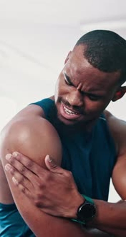 Black man, fitness and shoulder injury with pain or ache from accident or muscle tension at gym