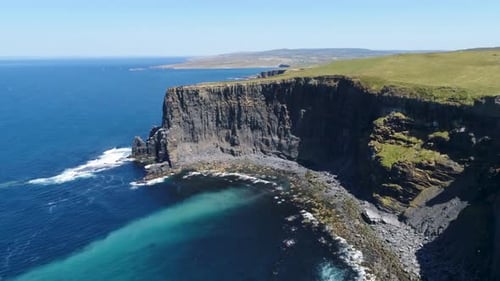 A drone shot of the Cliffs of Moher, the tallest sea cliffs of the rugged West Clare Coast of Irelan