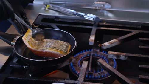 Chef Cooking Salmon Fillet in Frying Pan