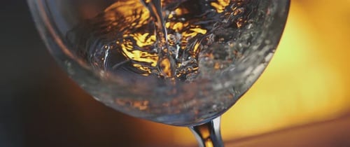 Liquid Pouring into Wine Glass in Close Up