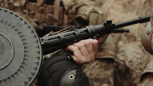 Soldier Holding Weapon in Camouflage Gear Close Up