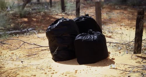 Litter Left Behind in a Dry Area Surrounded By Sparse Vegetation