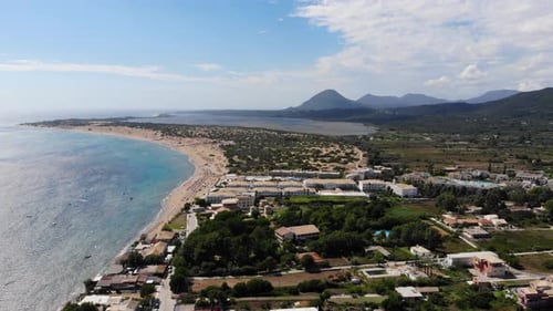 Aerial footage of the beautiful small town known as St George South in the city of Corfu Greece