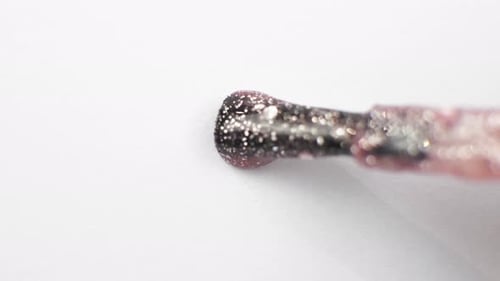 Pink Glitter Nail Polish Dripping from Brush