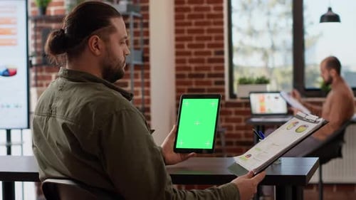 Adult Using Tablet with Green Screen in Office