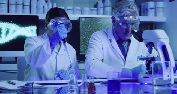 Two laboratory scientists testing phenolphthalein chemical reaction ...