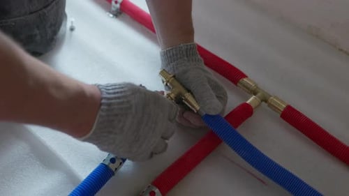 Connecting Brass Manifold Fitting to Plastic Pipes During Plumbing Installation