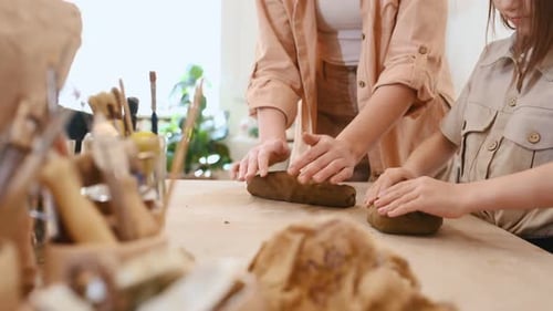 Child and Adult Working with Clay at Table