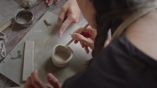 Woman Modeling Clay during Ceramics Workshop