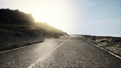 Scenic View of Empty Road Amidst Volcanic Landscape