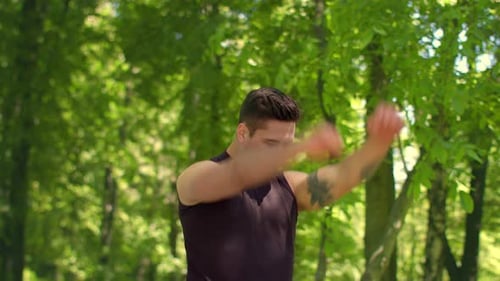 Fitness Man Exercising In Park. Fitness Exercise. Sport Guy Warming Up Shoulders Outdoor. Handsom...