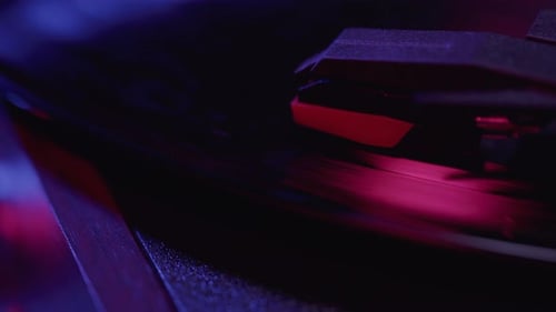 Close up of Vinyl Record player Spinning with cinematic red and blue lighting