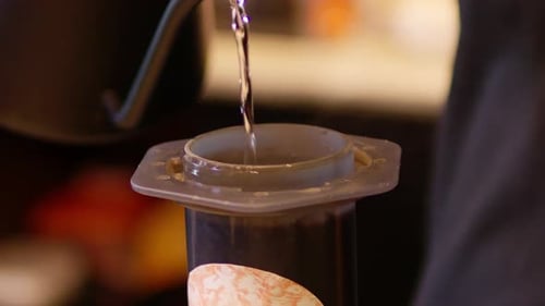 Pouring Hot Water Into Coffee Aeropress Maker