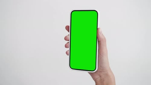Young Person Use Smartphone with Green Screen Chroma Key Close-Up. Girl Hold