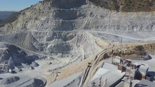 Aerial close view of a big quarry in a mountain.