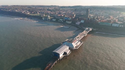 Aerial view of Cromer Pier in Norfolk, England, stretching into the sea at sunset